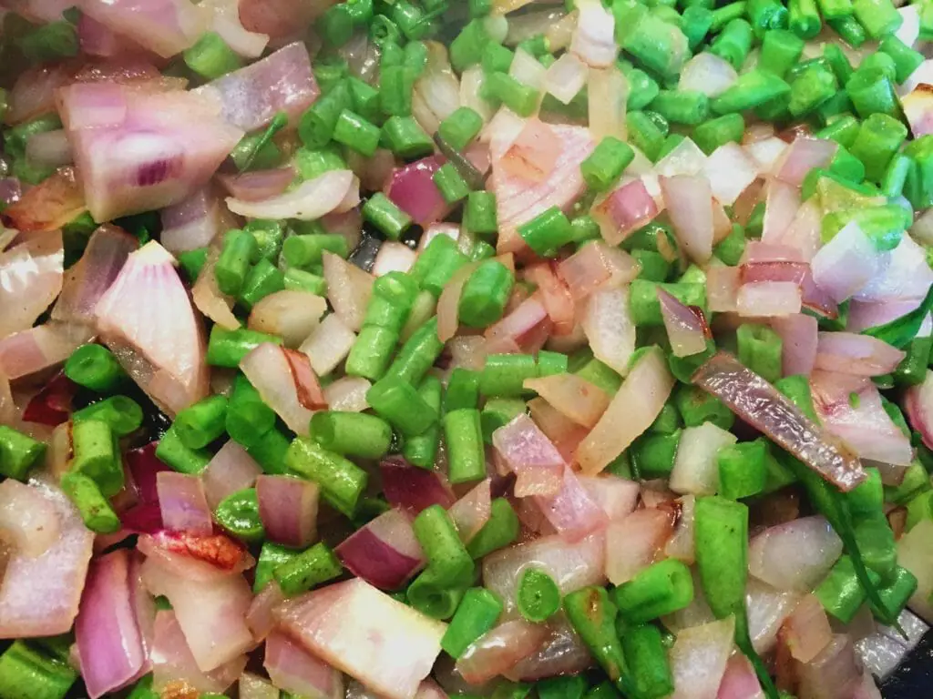 Saute onions and beans for Corned beef hash recipe 