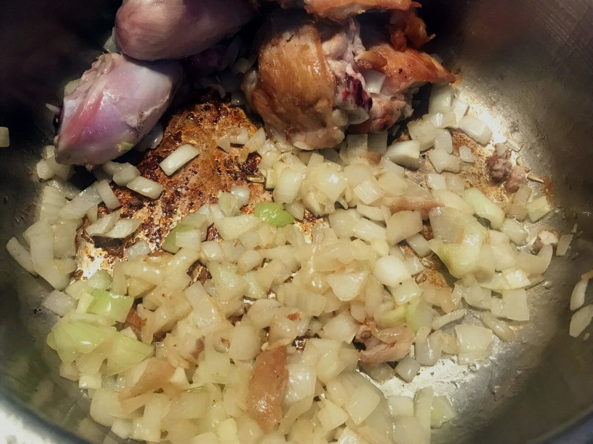 onions sauteed in a pan for chicken soup