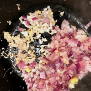 Add giner and garlic to sauteed onions for vegatable soup
