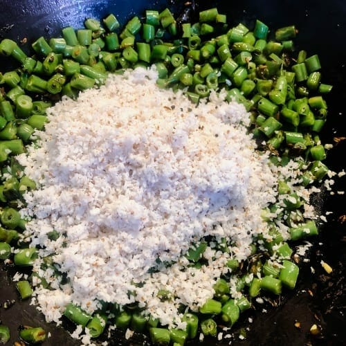 Add grated coconut to green beans 