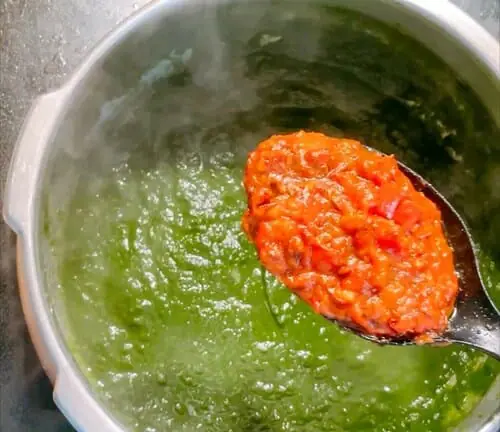 Add tomato masala base to spinach puree 