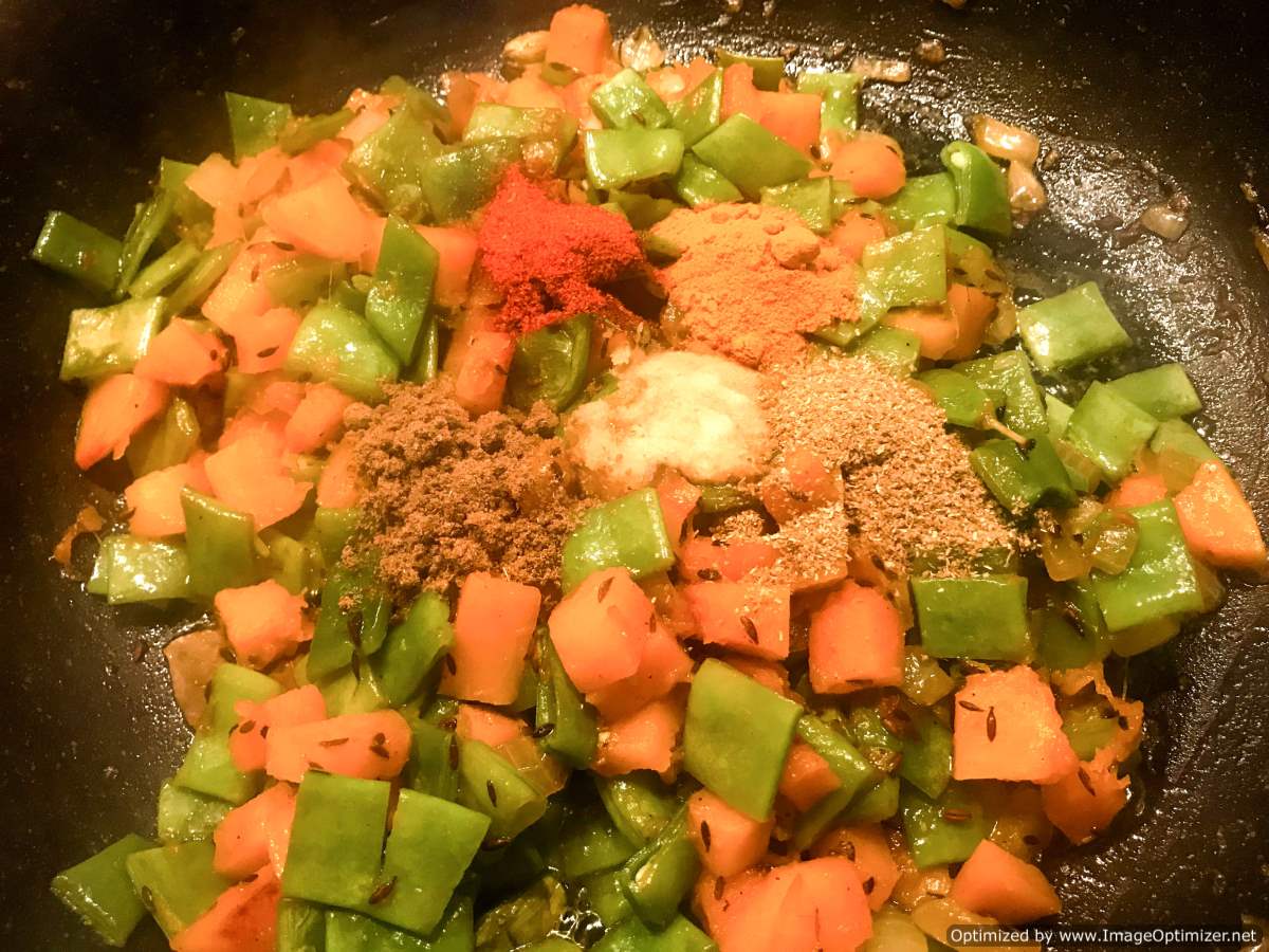 Add ground spices to pumpkin curry 