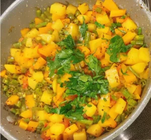 Indian style Pumpkin recipe in a pan with fresh coriander 
